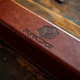 a brown leather book sitting on top of a wooden table